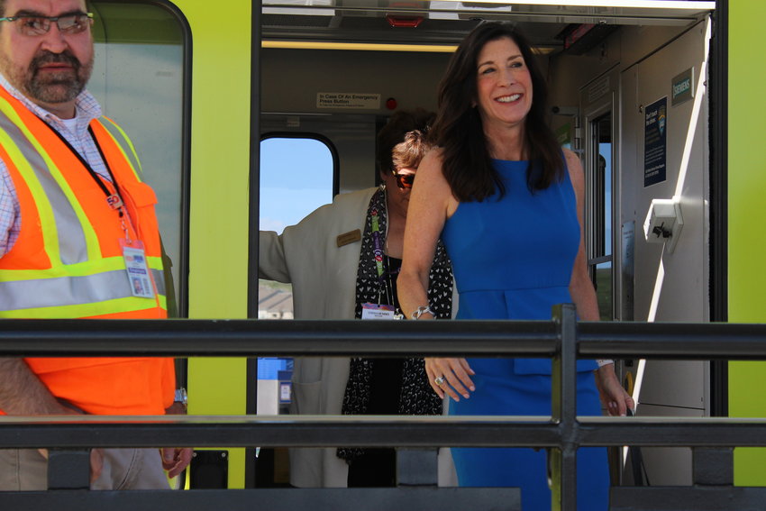 Mayor Jackie Millet steps off the train at the Sky Ridge Station May during the opening day celebration for the Southeast Rail Extension. The Sky Ridge Station is one of three stations part of the project that extends light rail 2.3 miles south.